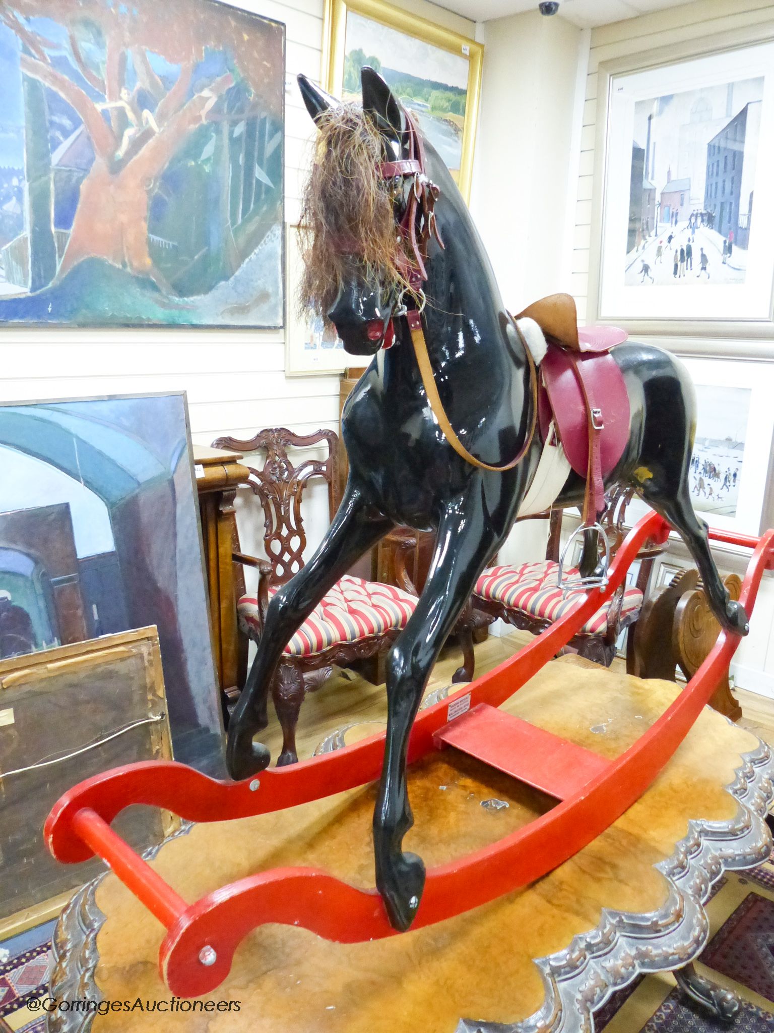 A fibre glass rocking horse, 151 cm long, 101 cm high
